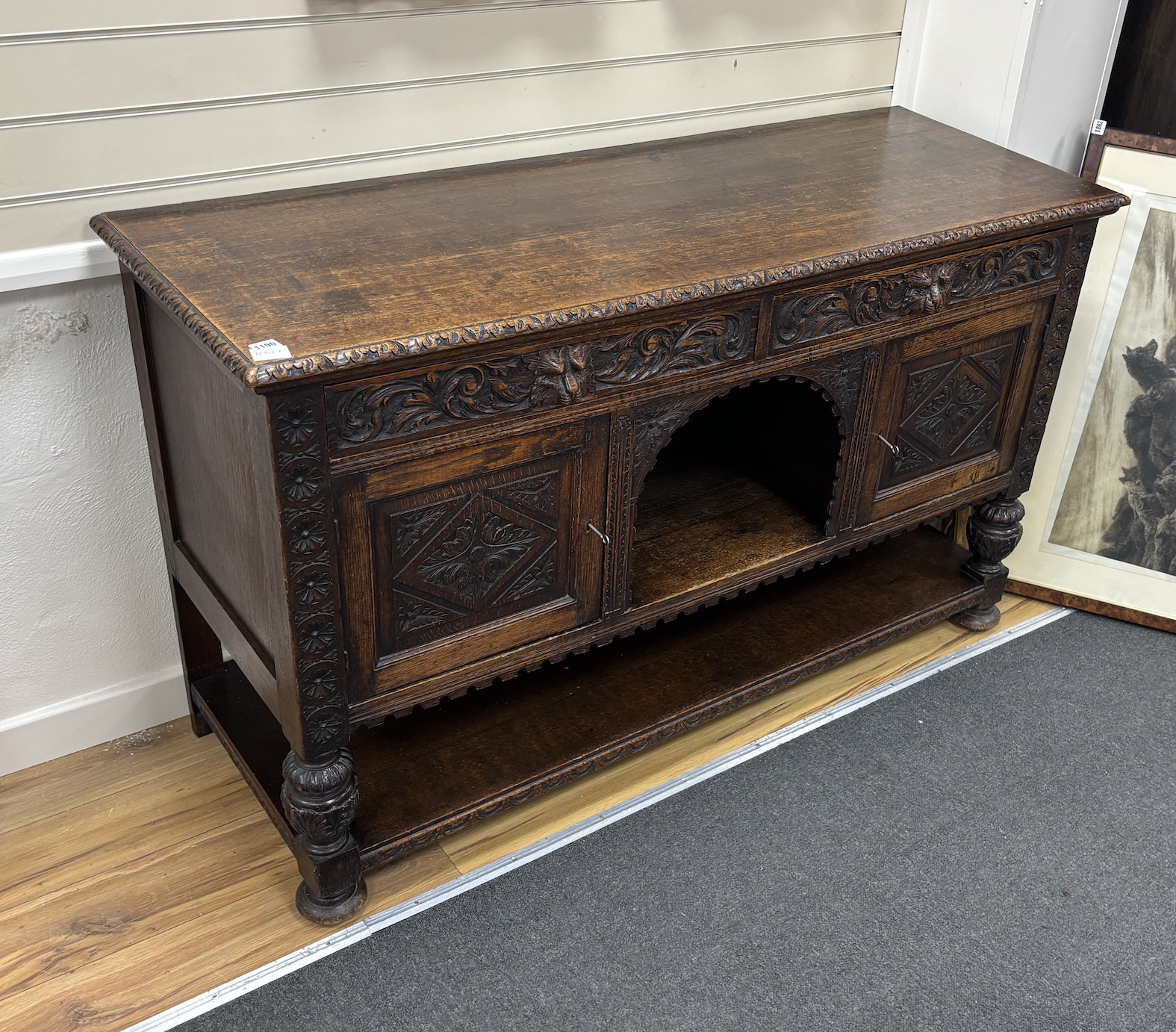 A late 19th century Flemish carved oak sideboard, length 152cm, depth 55cm, height 92cm